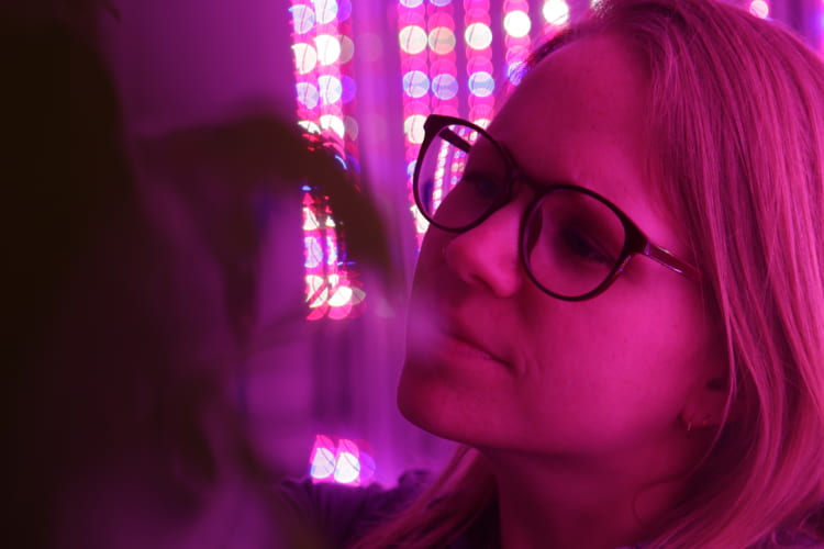 woman wearing glasses on purple blurry background