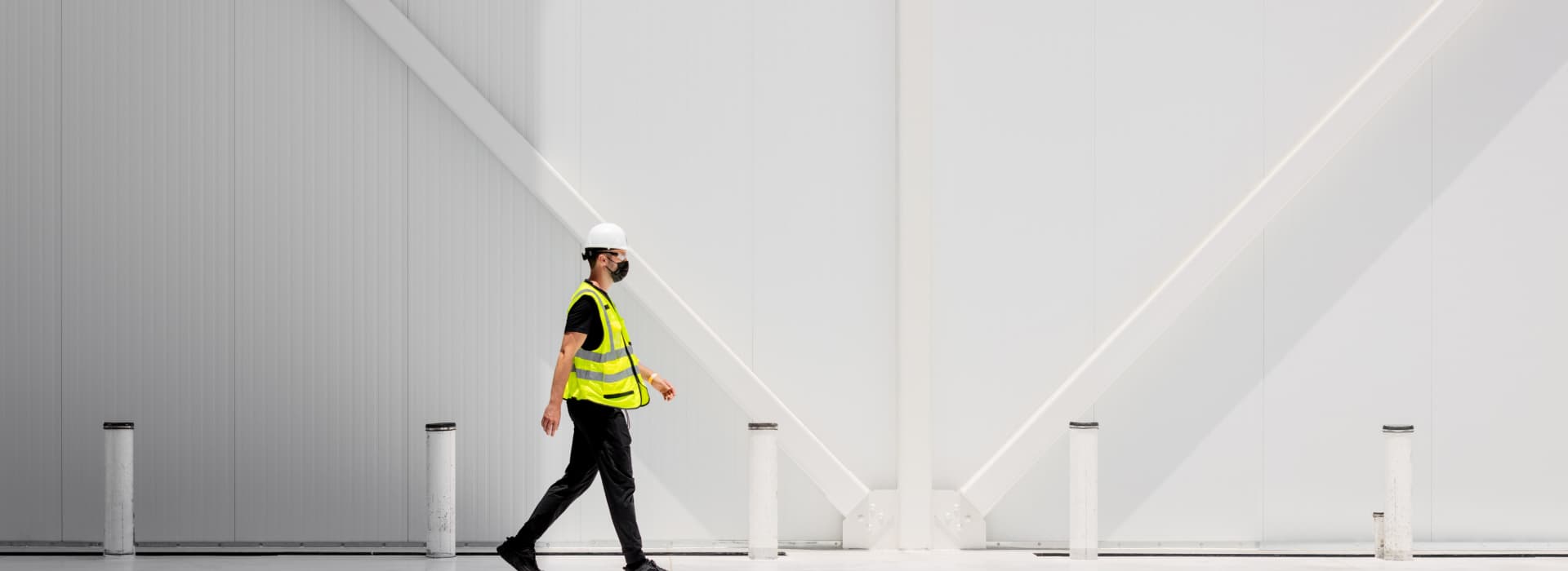 Man walking in front of Plenty's farm building